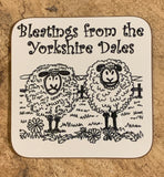 Image shows two cartoon drawn black and white  sheep,